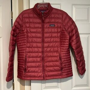 Patagonia women's down sweater jacket. Sz XL. Color is mauve/ dark pink. EUC